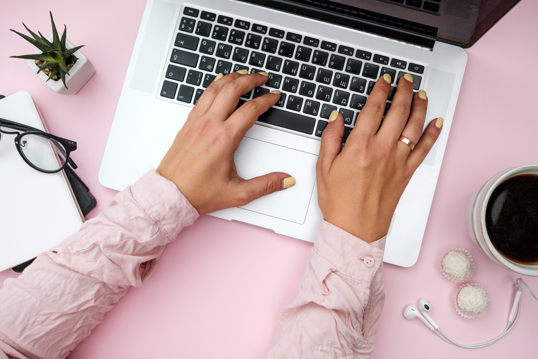 Hands writing content on laptop keyboard